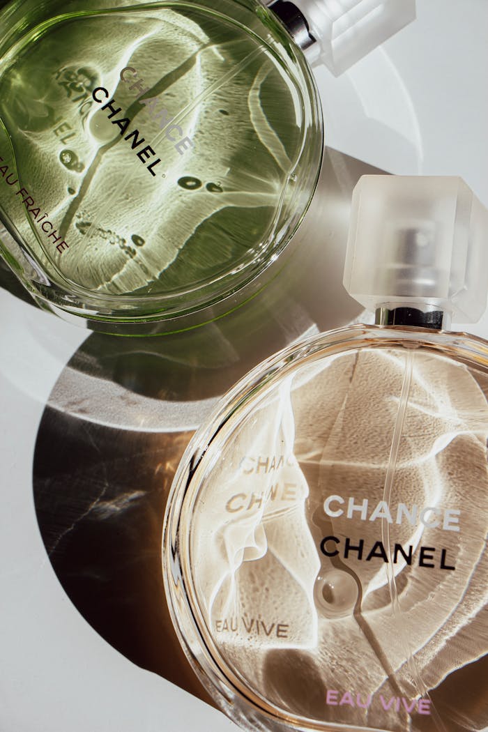 Elegant close-up of Chanel perfume bottles with artistic lighting effects.